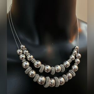 Multi-layer silver beaded necklace with clasp in back. 19” in length. Like new!